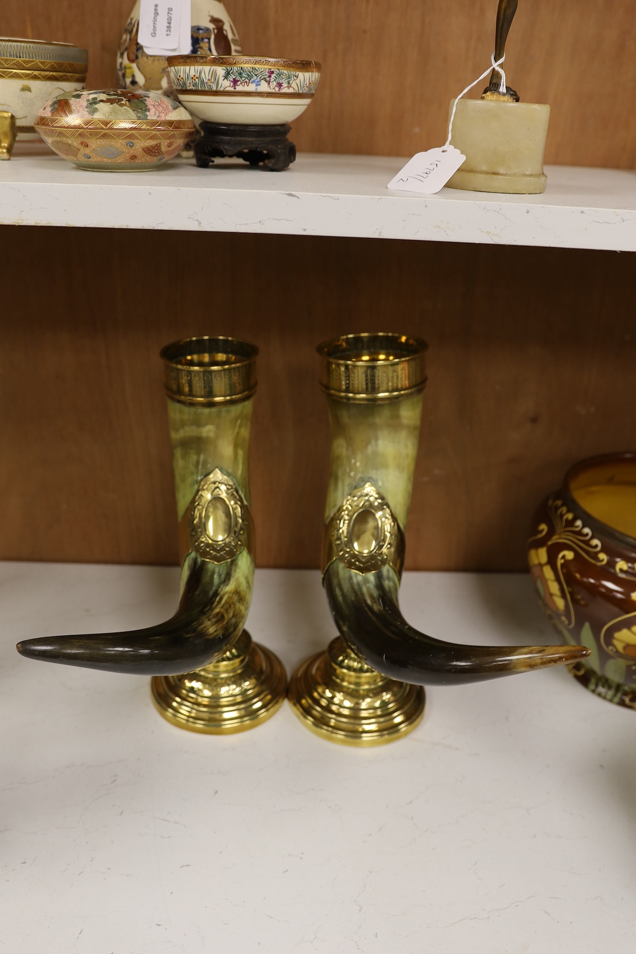 A pair of large decorative brass mounted horns, 33cm high. Condition - brass mounts dented and horns scratched in places